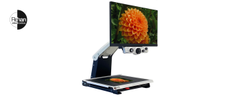 Rehan Electronics iSee desktop video magnifier with a large screen displaying an orange flower, mounted on an adjustable arm above a reading platform.