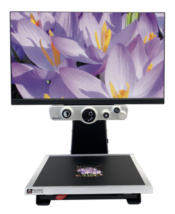 A close up image of i-SEE, a desktop magnifier showing a detailed photo of violet flowers.