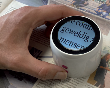 A close-up image of Looky round enlarging newsletter text.